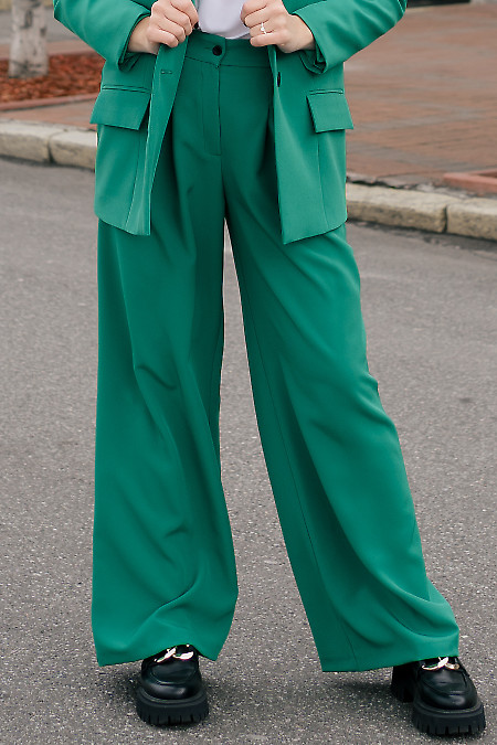 Штани палаццо якраво-зелені. Діловий жіночий одяг фото